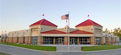 Font view of Funshine Kids Sale Building with American Flag waving in front